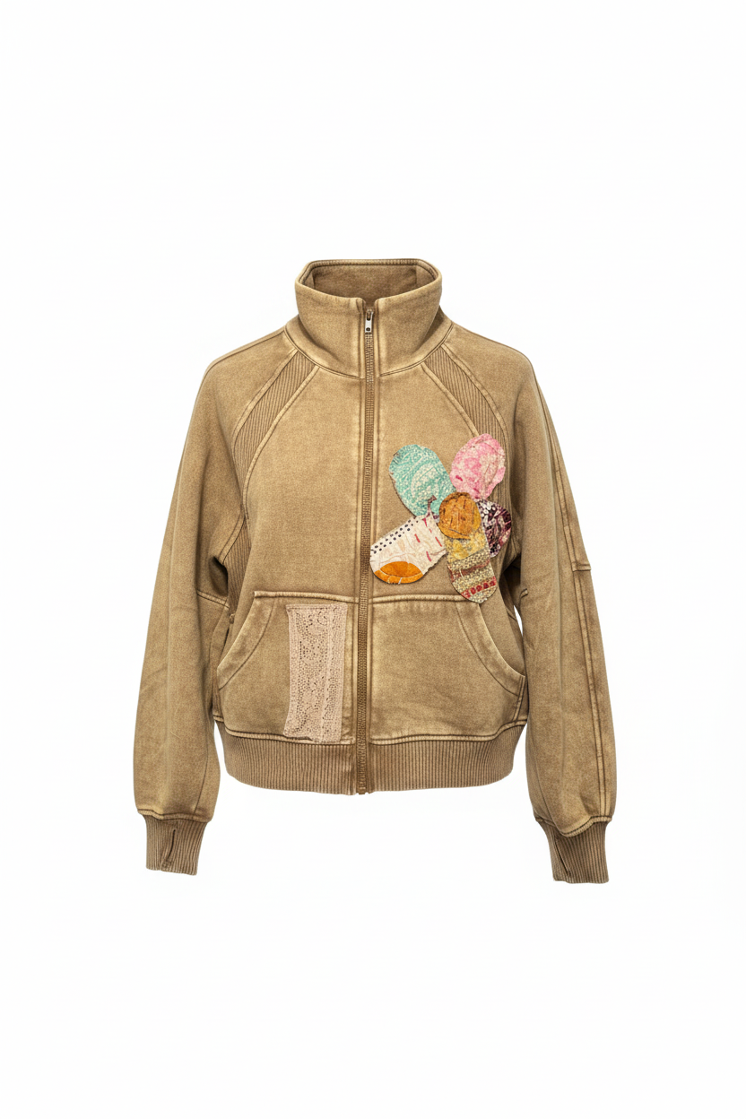 Professional studio photo of upcycled bomber jacket with floral appliqués